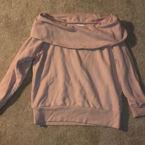A pink, off the shoulder long sleeve top.